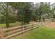 Expansive yard with a wooden fence and a horse grazing peacefully, offering a serene and rural setting at 2045 Marion County Rd, Weirsdale, FL 32195