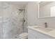 Bathroom featuring walk-in shower with sleek fixtures and white cabinets at 2680 Sw 144 Ct, Ocala, FL 34481