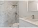 Bathroom featuring walk-in shower with sleek fixtures and white cabinets at 2680 Sw 144 Ct, Ocala, FL 34481