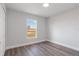 Bedroom with wood-look flooring and a window featuring natural light at 2686 Sw 144Th Ct, Ocala, FL 34481