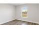 Bright bedroom features wood-look flooring and a window with natural light at 2686 Sw 144Th Ct, Ocala, FL 34481