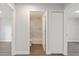 Hallway view of the bathroom with a tiled shower and a closet with bi-fold doors at 2686 Sw 144Th Ct, Ocala, FL 34481