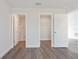 Bedroom view showcasing the interior doors, closet, and wood-look vinyl flooring at 2746 Sw 147Th Ct, Ocala, FL 34481