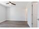 Bedroom featuring a ceiling fan, interior door, light gray walls, and wood-look vinyl flooring at 2746 Sw 147Th Ct, Ocala, FL 34481