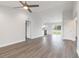 Spacious living room with ceiling fan, adjacent dining area, and stylish gray wood-look flooring at 2746 Sw 147Th Ct, Ocala, FL 34481