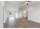 Open-concept living room featuring sliding glass doors, modern ceiling fan, and wood-look vinyl flooring at 2746 Sw 147Th Ct, Ocala, FL 34481