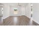 Open-concept living room with a bright interior, white walls, and wood-look floors at 2746 Sw 147Th Ct, Ocala, FL 34481