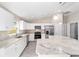 Bright kitchen with stainless steel appliances and white cabinets with marble countertops at 28 Pine Trace Run, Ocala, FL 34472