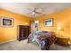 Another bedroom features a ceiling fan, dresser and brightly painted walls at 2840 Se 35Th St, Ocala, FL 34471