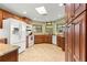 Well-lit kitchen featuring wood cabinets, granite counters, and a garden window for herbs at 2840 Se 35Th St, Ocala, FL 34471