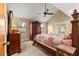 Comfortable main bedroom with vaulted ceiling, a ceiling fan, and classic wooden furniture at 2840 Se 35Th St, Ocala, FL 34471