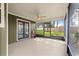 View of screened-in porch with ceiling fan and access to the backyard at 2840 Se 35Th St, Ocala, FL 34471