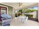 View of the screened in porch area with grill, table, chairs, and ceiling fan at 2840 Se 35Th St, Ocala, FL 34471