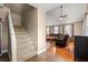 Carpeted staircase adjacent to a living area with hardwood floors and a leather sofa at 2840 Se 35Th St, Ocala, FL 34471