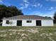 Backyard view with sliding glass doors and a tree on the side of the house at 301 Oak Track Way, Ocala, FL 34472