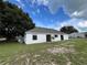 Backyard view with a tree on the side of the house at 301 Oak Track Way, Ocala, FL 34472