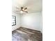 Bedroom featuring light wood floors, a ceiling fan, and a large window at 301 Oak Track Way, Ocala, FL 34472