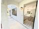 View from the doorway of a sunny living room with wood flooring, ceiling fan, and sliding glass doors at 301 Oak Track Way, Ocala, FL 34472