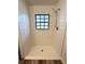 Shower room boasts new tile, flooring, and a window for natural light at 301 Oak Track Way, Ocala, FL 34472