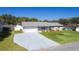 An aerial view of a brick home, showing the driveway and manicured front lawn at 3853 Se 60Th St, Ocala, FL 34480