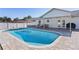 A picturesque swimming pool with a covered patio, ideal for outdoor living and entertaining at 3853 Se 60Th St, Ocala, FL 34480