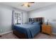 Bedroom with a bed, side table, and bright light from a window with views of the outdoors at 3853 Se 60Th St, Ocala, FL 34480