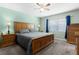 Comfortable bedroom featuring a wooden bed frame, neutral carpet, and bright natural light at 3853 Se 60Th St, Ocala, FL 34480