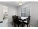 Dining room area with a dark wood table, four chairs, and a large window at 3853 Se 60Th St, Ocala, FL 34480