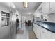 Well-lit kitchen features white cabinets, stainless steel appliances, and an adjacent dining area at 3853 Se 60Th St, Ocala, FL 34480