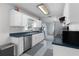 Well-lit kitchen with white cabinets, stainless steel appliances and blue countertops at 3853 Se 60Th St, Ocala, FL 34480