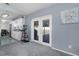 Cozy living room featuring sliding glass doors, a gray carpet, and a kitchen in the background at 3853 Se 60Th St, Ocala, FL 34480