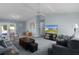 Comfortable living room featuring plush gray sofas, a ceiling fan, and outdoor view at 3853 Se 60Th St, Ocala, FL 34480