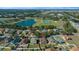 An aerial view of the home and its neighborhood amenities with a community pool, lake and sports courts at 3999 Sw 51St Ct, Ocala, FL 34474