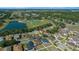 An aerial view of the home and its neighborhood amenities with a community pool, lake and sports courts at 3999 Sw 51St Ct, Ocala, FL 34474