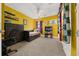 Yellow bedroom featuring a day bed, carpet, ceiling fan, and bookshelf with decorations at 3999 Sw 51St Ct, Ocala, FL 34474