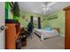 Bright bedroom with green walls, carpet flooring, ceiling fan, and large window at 3999 Sw 51St Ct, Ocala, FL 34474