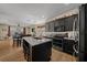 Modern kitchen featuring dark cabinets, granite countertops, and stainless steel appliances at 3999 Sw 51St Ct, Ocala, FL 34474