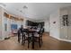 Eat-in kitchen features dark wood cabinetry and a dining table next to a bright window at 3999 Sw 51St Ct, Ocala, FL 34474