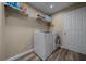 Laundry room with washer, dryer, wire shelves and wood-look vinyl flooring at 3999 Sw 51St Ct, Ocala, FL 34474