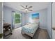 Serene bedroom with a ceiling fan, a large window, and carpet flooring at 4160 Sw 98Th St, Ocala, FL 34476