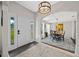 Welcoming foyer leading to the dining room, featuring a modern chandelier and wood-look floors at 4160 Sw 98Th St, Ocala, FL 34476