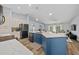 Bright, open kitchen featuring a blue island with quartz countertops and modern appliances at 4160 Sw 98Th St, Ocala, FL 34476