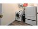 This laundry room features a modern washer and dryer with a storage shelf at 4160 Sw 98Th St, Ocala, FL 34476