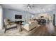 Bright living room with modern furniture, ceiling fan, and seamless flow into the kitchen area at 4160 Sw 98Th St, Ocala, FL 34476