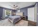 Comfortable main bedroom featuring a ceiling fan, and a beautiful view of the pool at 4160 Sw 98Th St, Ocala, FL 34476