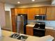 Kitchen featuring oak cabinets, stainless steel refrigerator and appliances at 4525 Sw 52Nd Cir # 105, Ocala, FL 34474