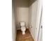 Compact toilet room with tile flooring, a standard toilet, and essential fixtures at 4525 Sw 52Nd Cir # 105, Ocala, FL 34474