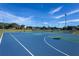 Outdoor basketball court surrounded by lush green grass, offering a perfect space for recreational activities and sports at 4555 Sw 52Nd Cir # 103, Ocala, FL 34474