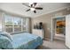 Cozy bedroom with a ceiling fan, a large window, and a view into the kitchen area at 4555 Sw 52Nd Cir # 103, Ocala, FL 34474