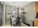 Bright dining area featuring tiled floors, a modern light fixture, and a picturesque view from the window at 4555 Sw 52Nd Cir # 103, Ocala, FL 34474